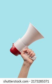 Megaphone in woman hands on a white background.  Copy space.  - Shutterstock ID 2173285371