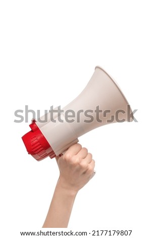 Megaphone in woman hands on a white background.  Copy space. 