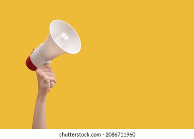 Megaphone in woman hands on a yellow background.  Copy space.  - Shutterstock ID 2086711960
