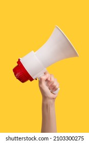Megaphone in woman hands on a yellow background.  Copy space. 