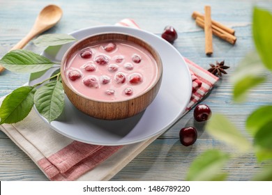 Meglevesh, hungarian cold cherry soup, served in wooden bowl 
