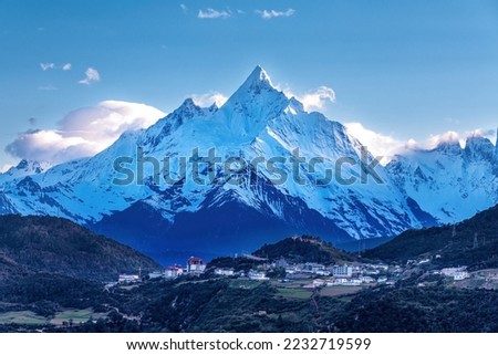 Meili Snow Mountain and town landscape in Deqen prefecture Yunnan province, China.	
