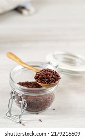 Meises Chocolate Sprinkles or Chocolate Granulado on Wooden Spoon. Sweet Baking Ingedients