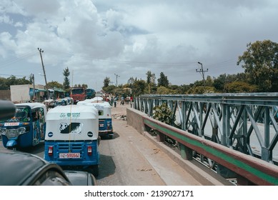 Meki, Oromia Region, Ethiopia - May 16, 2019: Cars And Rickshaw Known As Tuk Tuk Meki On Main Street Of Meki, Oromia Region, Ethiopia, Africa