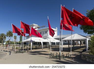 MEKNES, MOROCCO - JULY 23: Moroccon flags in front of the Railway Station as on July 23, 2014 in Meknes, Morocco. Rail transport in Morocco is operated by the ONCF.
