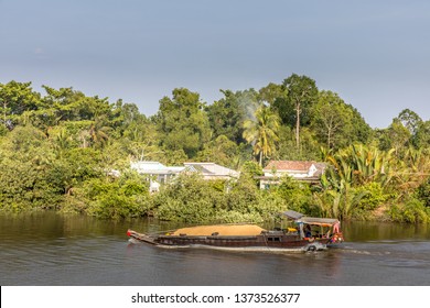 Mekong Delta / Vietnam - March 04 2019: A Transportation Boat With Yellow Sand On The Mekong Delta In A Beautiful Landscape.