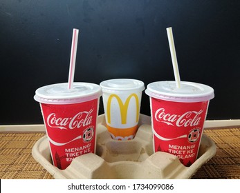 Melaka, Malaysia, Apr 26 2020:
3 Cups Of McDonald's Cola With Straw In A Cardboard Tray And Black Background 