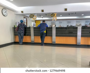 Melaka, Malaysia - Circa January, 2019: Customer At The Bank Counter / Bank Teller