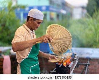 Melaka, Malaysia- Circa November 2019; A Malay Man Char Grilling  Chicken Satay At His Hawker's Stall. Satay Is A Popular Dish In Malaysia. Originated From Indonesia.