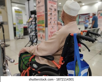 Melaka - Malaysia - December 12, 2020 : An Old Man Was Sitting In A Wheelchair Waiting For His Turn To See A Doctor At The Clinic.