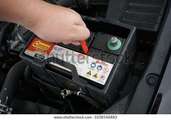 Melaka, Malaysia - March 3, 2018: Process of\
changing the car battery using\
tools.