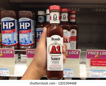 MELAKA, MALAYSIA- OCTOBER 12,2018: Hand Holding Brand's A1 Steak Sauce Bottle On Supermarket Store.