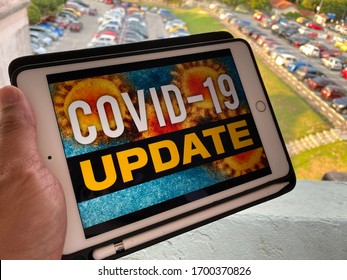 Melaka/Malaysia - April 10,2020 : A Slight Blur Image Of Man Watching Covid-19 News Update On His IPad