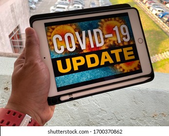 Melaka/Malaysia - April 10,2020 : A Slight Blur Image Of Man Watching Covid-19 News Update On His IPad