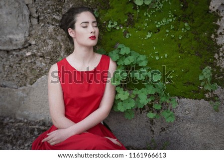 Similar – Melancholic girl with red dress in nature