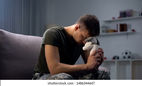 Melancholic Male Soldier Holding Toy Dog, Missing Child After Divorce, Lonely