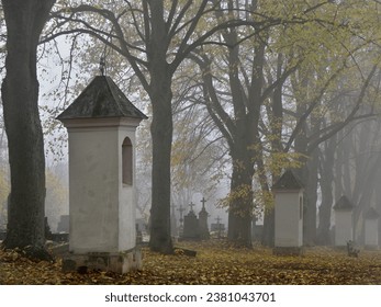 Melancholic mood in a foggy old Christian cemetery. The road through Calvary.