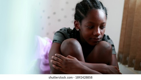Melancholical sad girl. Black teenager African young suffering from depression