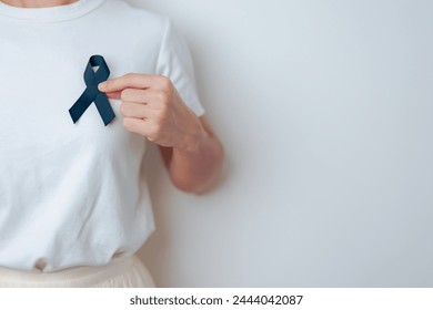 Melanoma and skin cancer, Vaccine injury awareness month and rest in peace concepts. woman holding black Ribbon - Powered by Shutterstock