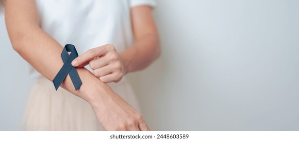 Melanoma and skin cancer, Vaccine injury awareness month and rest in peace concepts. woman holding black Ribbon - Powered by Shutterstock