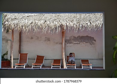 Melaque, Mexico. March 2020. Cabana With Five Lounge Chairs And One Man Sitting.