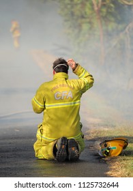 Melbourne, Australia - April 13, 2018: Exhausted Fire Fighter At A Bush Fire In An Suburban Area Of Knox City In Melbourne East.