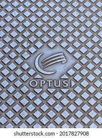 Melbourne, Australia, August 1, 2021: A Metal Manhole Cover With The Optus Label And Logo On The Surface.