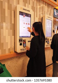 Melbourne, Australia - Circa March, 2019: Women Purchasing Fast Food / Burgers From The Online Self Service McDonalds Terminal.