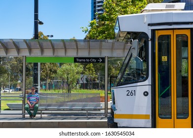 Melbourne, Australia - December 7, 2016: Person Waiting On A Tramway Station With Tramway Approaching. Melbourne Public Transport 