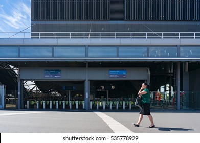 Melbourne, Australia - December 7, 2016: Southern Cross Station Platform Entrance With Pay, Ticket Gates And Woman Walking And Talking Phone