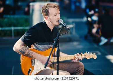 MELBOURNE, AUSTRALIA - Feb 05, 2022: A Guitar Player Busking In The Streets Of Melbourne 