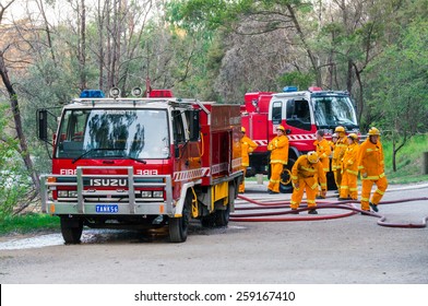 MELBOURNE, AUSTRALIA - February 10, 2015: Volunteer Fire Fighters From The North Warrandyte Brigade Of The Country Fire Authority Practicing By The Yarra River In Warrandyte, With Isuzu Fire Trucks.