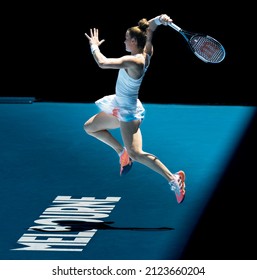 MELBOURNE, AUSTRALIA - Jan 21, 2022: The Tennis Player Maria Sakkari Hits A Forehand As She Jumps Back Over The Melbourne Logo