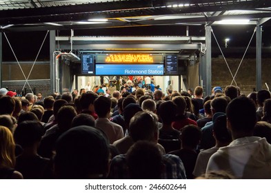 MELBOURNE, AUSTRALIA - January 20, 2015: People Queuing To Enter Richmond Train Station After The End Of An AFC Asian Cup Soccer Match At The Nearby Melbourne Rectangular Stadium