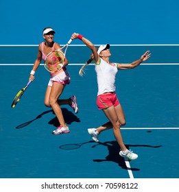MELBOURNE, AUSTRALIA - JANUARY 28: Maria Kirilenko (R) & Victoria Azarenka in the women's doubles final at the Australian Open on January 28, 2011 in Melbourne, Australia