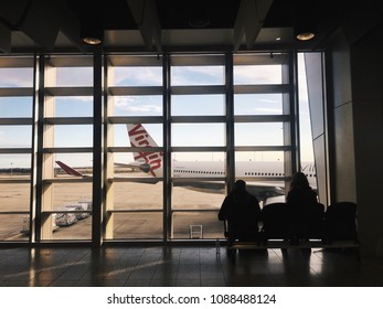 Melbourne, Australia - July 22, 2017: Blurred Passengers Are Waiting To Board Their Flight. Virgin Airline's Airplane Is On The Background Of The Scene. 