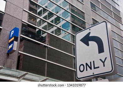 MELBOURNE, AUSTRALIA - JULY 30, 2018: Arrow Sign To Only Turn Left To A Parking Building And No Entry Sign