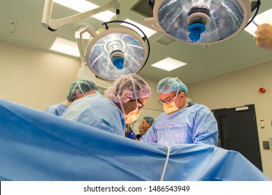 Melbourne, Australia - June 7, 2019: Surgeons Performing A Caesarean Section In An Operating Theatre In The Royal Women's Hospital.