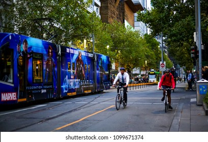 MELBOURNE, AUSTRALIA - MARCH 15, 2018 : Cyclist At Melbourne City Center. People Using Bicycle For Commute To Work Or Food Delivery.