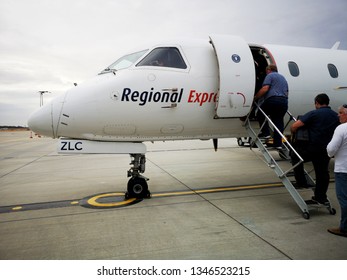 Melbourne, Australia: March 2019: Rex Regional Is A Small Airline Providing Transportation To Small Regional Towns Including Melbourne To Burnie. Passengers Board Their Flight.