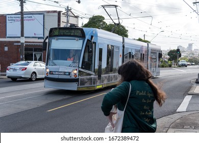 Melbourne / Australia - March 7, 2020: A Lady Catching A Tram From The Suburb Of Brunswick West Into The City Of Melbourne