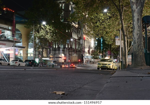 MELBOURNE, AUSTRALIA - MAY 06, 2013: Taxi cabs and\
night on Bourke street at night on May 6, 2013, Melbourne,\
Australia. Bourke street is one of central streets in Melbourne\
with offices and\
shops