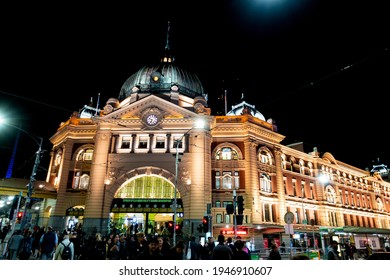 Melbourne, Australia - May 15, 2019: Lit Up Night View Of The Iconic Flinders Street Station. Street View From Swanston Street. Busy Night Life In The Surrounding Areas.