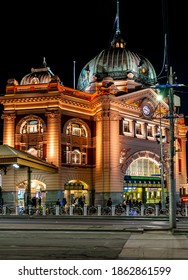 Melbourne, Australia - May 17, 2019: Lit Up Night View Of The Iconic Flinders Street Station. Street View From Swanston Street. Busy Night Life In The Surrounding Areas.