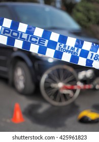 Melbourne, Australia -May 21, 2016: Blue And White Police Tape Used To Cordon Off A Damaged Bicyle Under A Car And Like A Crime Scene, Australia 2016