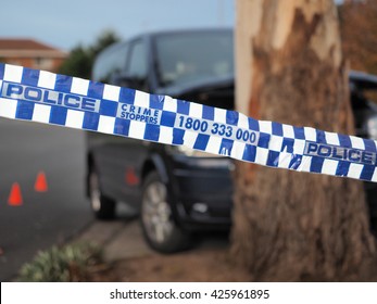 Melbourne, Australia -May 21, 2016: Blue And White Police Tape Cordoning Off A Van Crushed Into A Tree Like A Crime Scene, Australia 2016