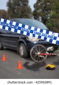 Melbourne, Australia -May 21, 2016: Police Tape Cordoning Off A Damaged Bicyle Under A Car Like A Crime Scene, Australia 2016