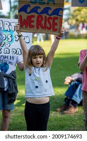 MELBOURNE, AUSTRALIA - May 21, 2021: Primary School Children With Their Parents At Climate Change Protest In Melbourne  Kids Holding Global Warming Signs March At A Rally For Climate