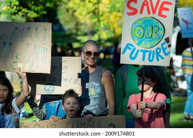 MELBOURNE, AUSTRALIA - May 21, 2021: Primary School Children With Their Parents At Student Climate Change Strike Marching Down The Street With Signs Fighting For Climate Action