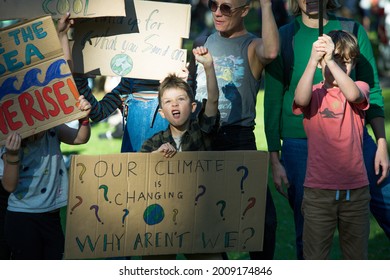 MELBOURNE, AUSTRALIA - May 21, 2021: Primary School Children With Their Parents At Student Climate Change Strike  Kids March Down The Street Holding Signs Fighting For Climate Action 